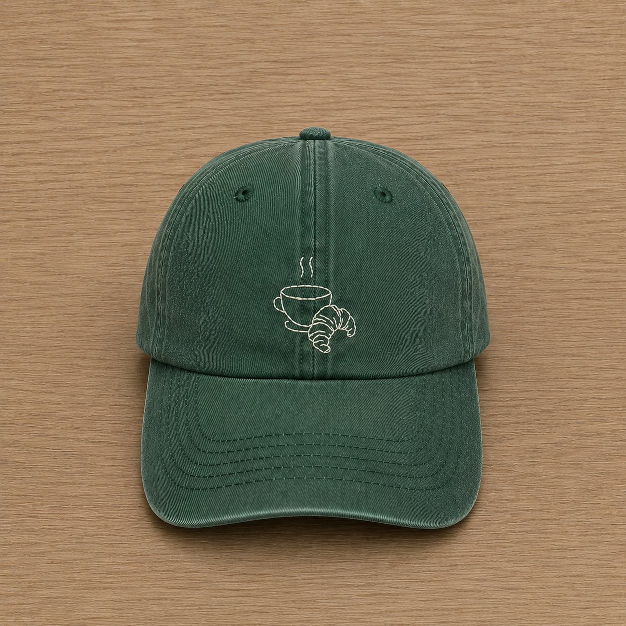 Forest green cap with hand-embroidered coffee and croissant