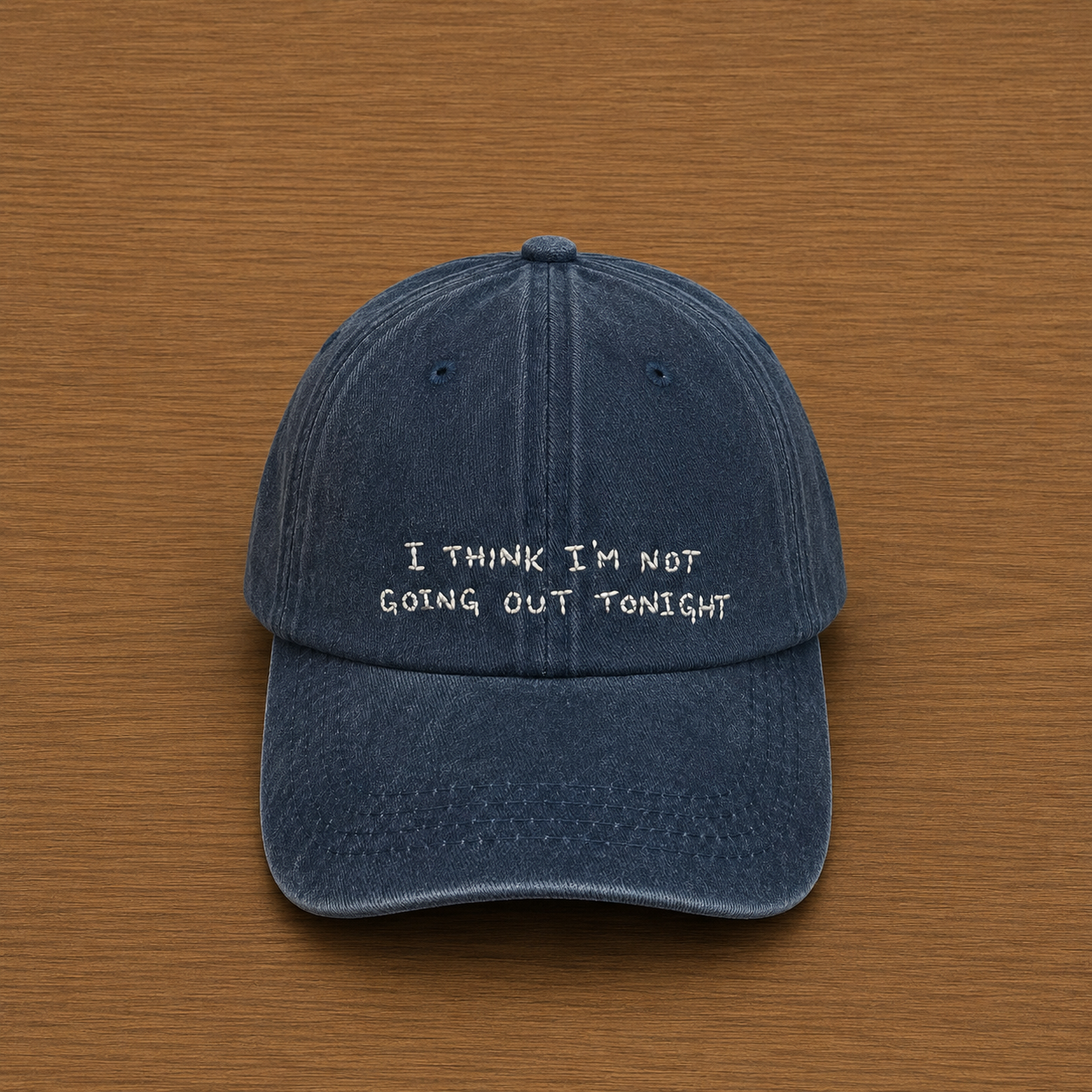 Dark blue cap with "I think I'm not going out tonight" hand-embroidered